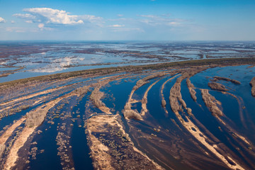 Aerial view of flood-land beside great river during spring