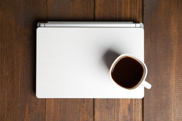 Cup of coffee on laptop