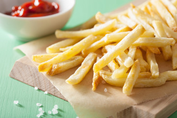 french fries with ketchup over green background