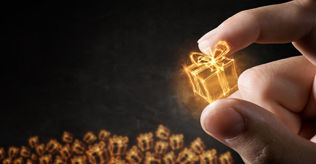 Fototapeta premium Glowing symbol between fingers