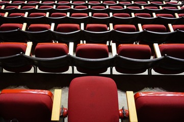 Folded red seats at a multipurpose arena and sports stadium
