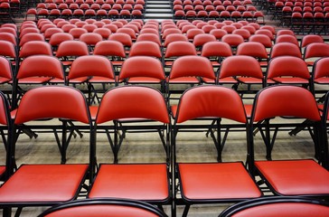 Folded red seats at a multipurpose arena and sports stadium