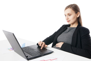 Portrait of pregnant businesswoman working on laptop