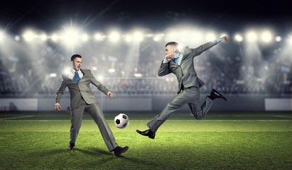 Obraz na płótnie Canvas Two businessmen fight for ball