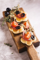 Tasty breakfast toasts on wooden board