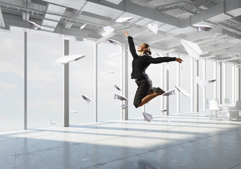 Dancing businesswoman in office