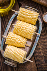 corn cob for grill on wooden table