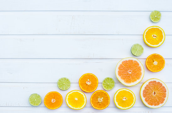 Colorful citrus fruits on the rustic white background. Flat lay.