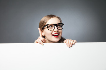 woman with finger up looking at camera