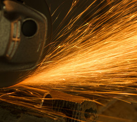 Sparks from cutting metal abrasive disk of angle grinder