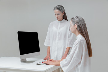 Two women using computer, pc