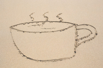 cup of coffee drawn on sand