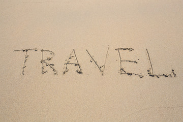 written words travel on sand of beach