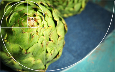 Artichokes on color wooden background. Golden Ratio concept