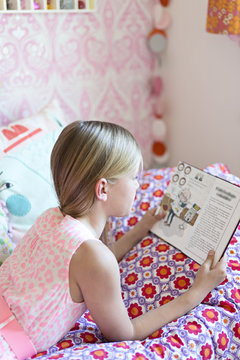 Girl reading in her room
