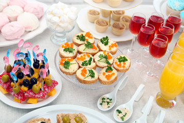 Set of cold snacks, canape, beverages and dessert, closeup