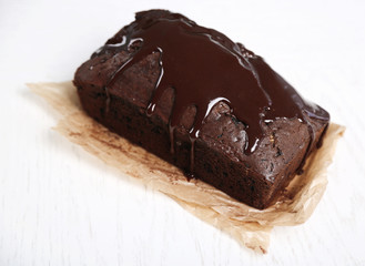 Chocolate cake with icing on white table