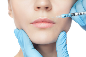 Attractive woman at plastic surgery with syringe in her face