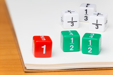 fraction dices on white notebook