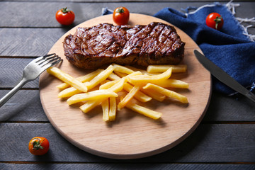 Grilled steak with french fries and cherry tomatoes, closeup