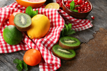 Juicy composition of tropical fruits on wooden background
