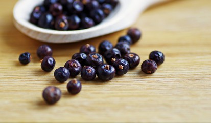 Juniper berries. Juniper. Juniper berry spices on a wooden background.