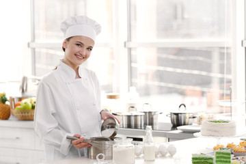 Female chef working at kitchen