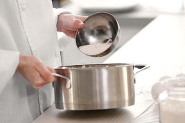 Female chef working at kitchen