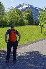 Fototapeta premium hiker girl with backpack look to the mountain