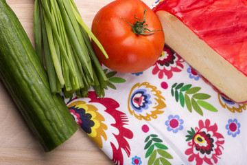 cheese, tomatoes, cucumber szczypioerk n wooden board