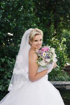 Portrait of bride with bouquet in hands