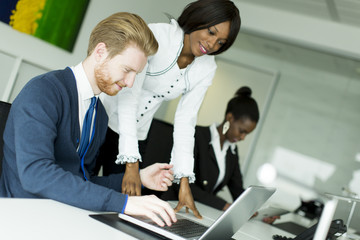 Fototapeta premium Young business couple using laptop in the office