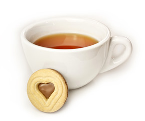 Cup of tea with cookie with heart-shaped chocolate filling