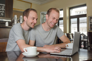 Gay couple looking through their photos together