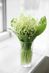 Bouquet of lilies of the valley on windowsill