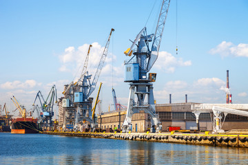 Fototapeta na wymiar View of seaport wharf with cranes in Gdansk, Poland.