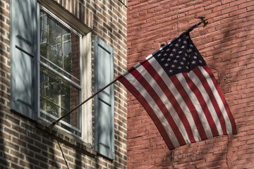American flag outside a colonial home
