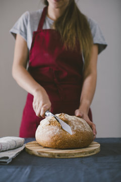 Woman chopping fresh hand made bread