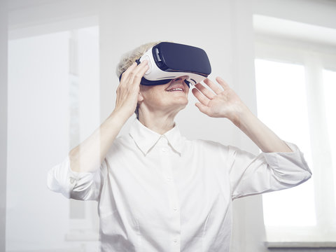 Senior woman wearing Virtual Reality Glasses