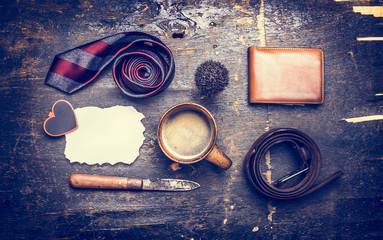 toned concept of the day of his father, a cup of coffee, tie, belt, knife, leather wallet, place for text on a postcard