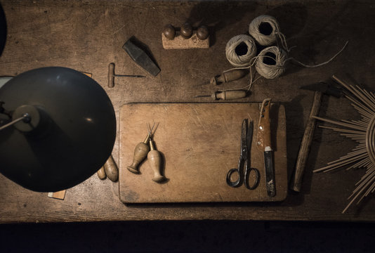 Tools and twine rolls on a wood table in a workshop