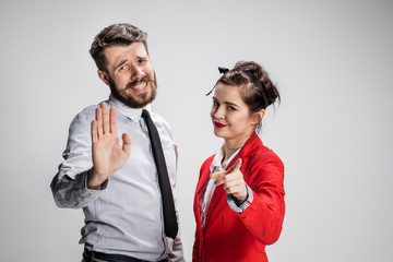 The business man and woman communicating on a gray background