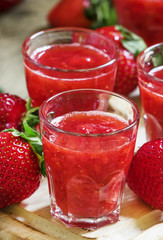 Strawberry juice, vintage wooden background, selective focus