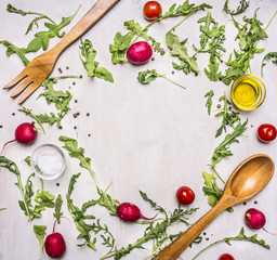 Healthy foods, cooking and vegetarian concept salad with cherry tomatoes, radishes, spices and wooden spoon and for place for text,frame