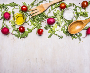 Healthy foods, cooking and vegetarian concept salad with cherry tomatoes, radishes, spices and wooden spoon and fork border ,place for text