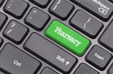 Computer keyboard closeup with "Pharmacy" text on green enter key