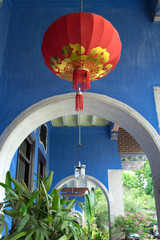 Red Chinese lantern against blue wall of Cheong Fatt Tze Mansion in Georgetown, Penang, Malaysia　ペナン島のブルーマンション