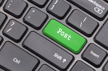 Computer keyboard closeup with "Post" text on green enter key