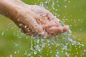 Fototapeta premium washing hands on nature background, closeup