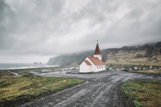 Iceland, Vik, view to village and church, dramatic sky